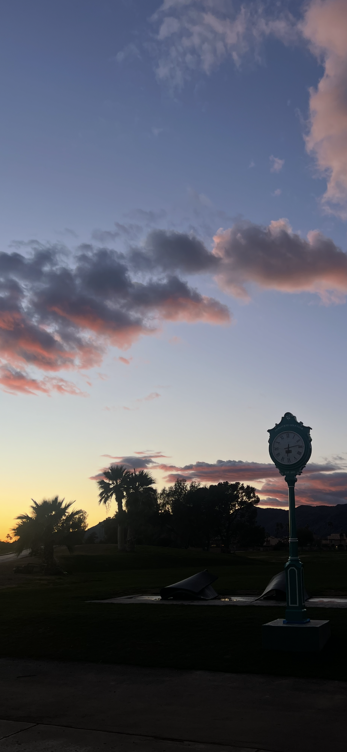 Fluffy Clouds at sunset over golf course 