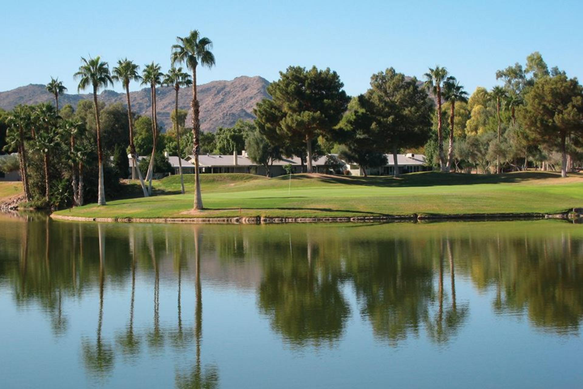 Pond on golf course with trees